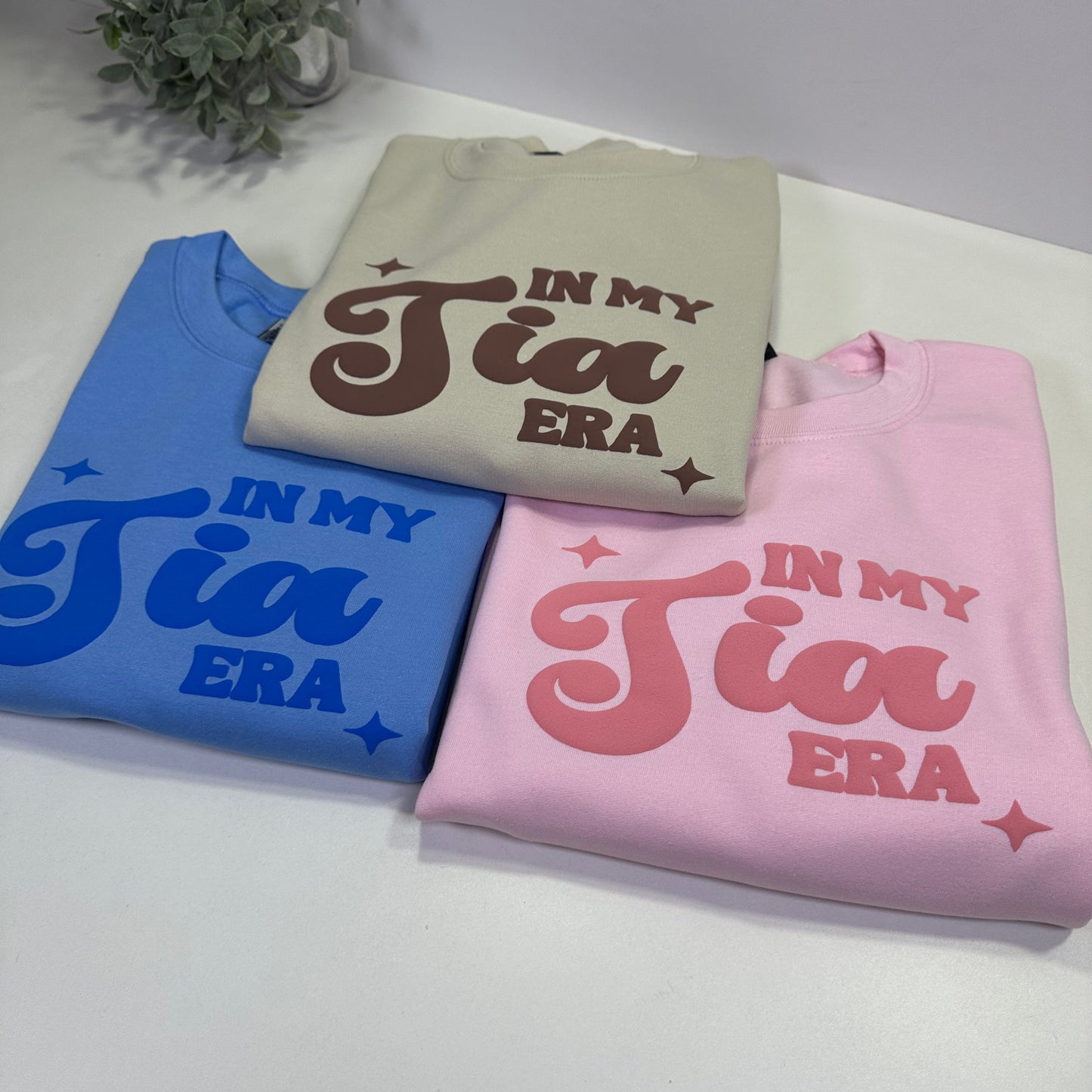 3 in my tia era sweatshirt monochromatic design, on in sand color, pink color and blue color