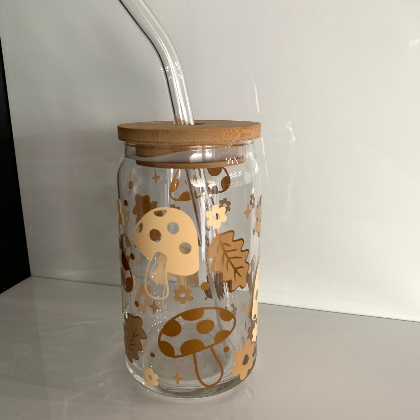 tumbler glass cup with mushroom, flowers and leaves in natural color as a cup design with a bamboo lid and straw
