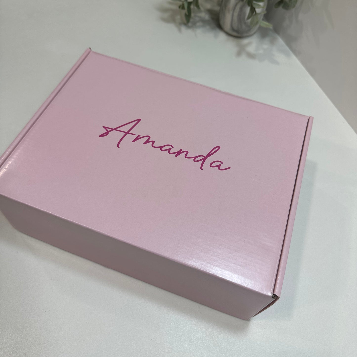 light pink box with name in dark pink