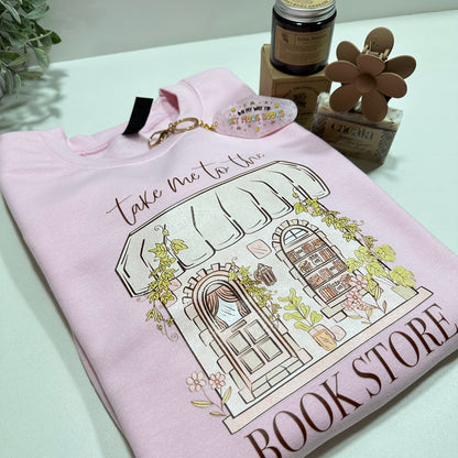pink bookish sweatshirt, key motel keychain, a candle, a soap and a flower hair clip