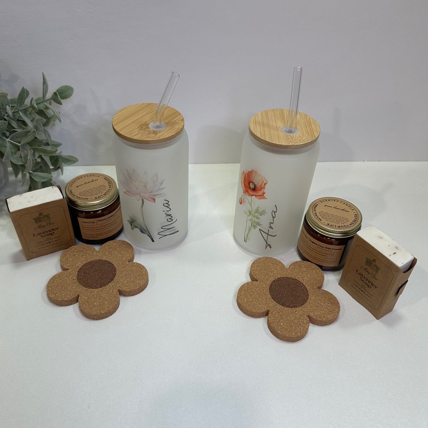 a pair of Flower cups with name, candle, flower coaster and a soap in a white background