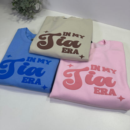 3 in my tia era sweatshirt monochromatic design, on in sand color, pink color and blue color