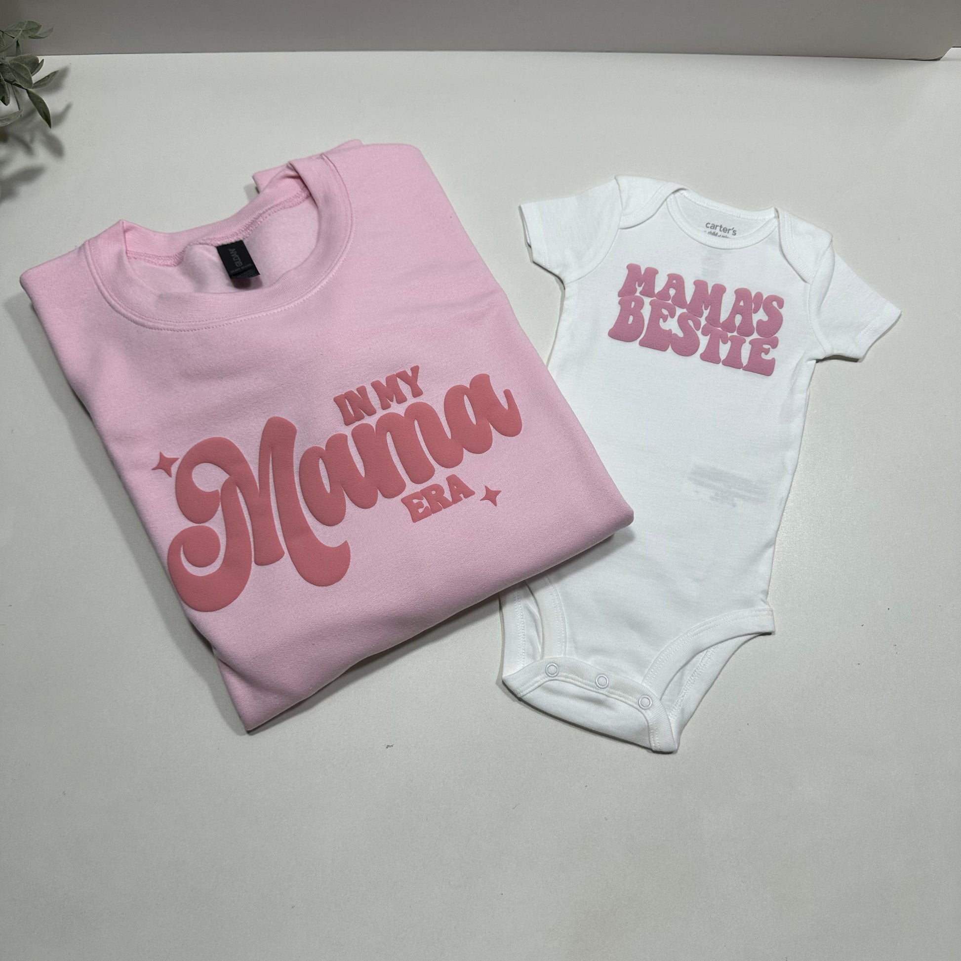 Pink sweatshirt that said in my mama era in dark pink and white onesie with mama's bestie design in pink