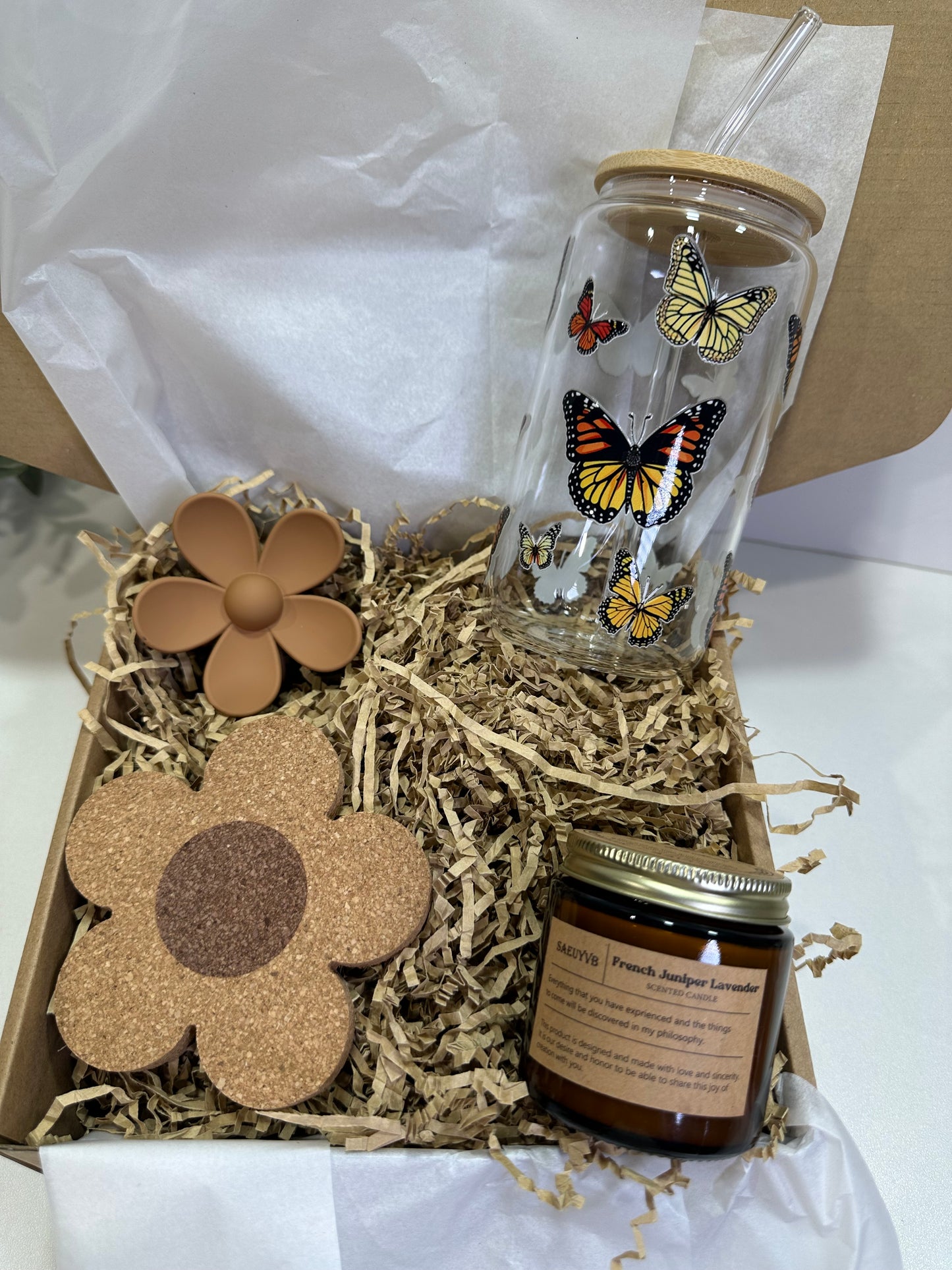 Gift set with a glass tumbler, jar, and flower-shaped coasters in a box.