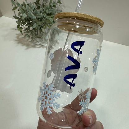 Clear glass tumbler with straw and snowflake design held by a hand, with a Ava Name in blue on it
