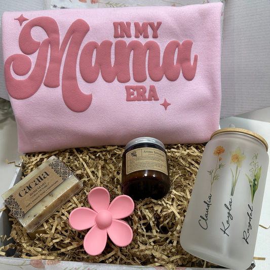 gift box wit an organic soap, organic candle, in my mama era pink sweatshirt, pink flower hair clip, personalized glass can cup