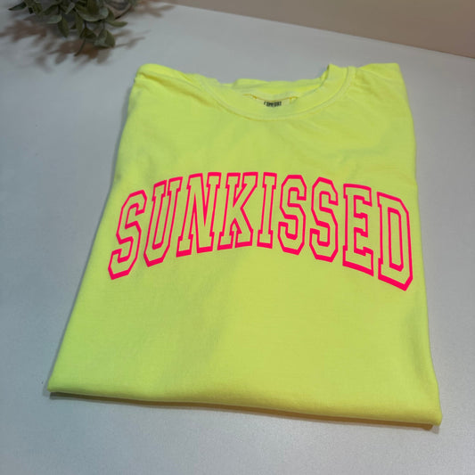 neon lemon shirt lay down with neon pink Sunkissed puff design on a white background