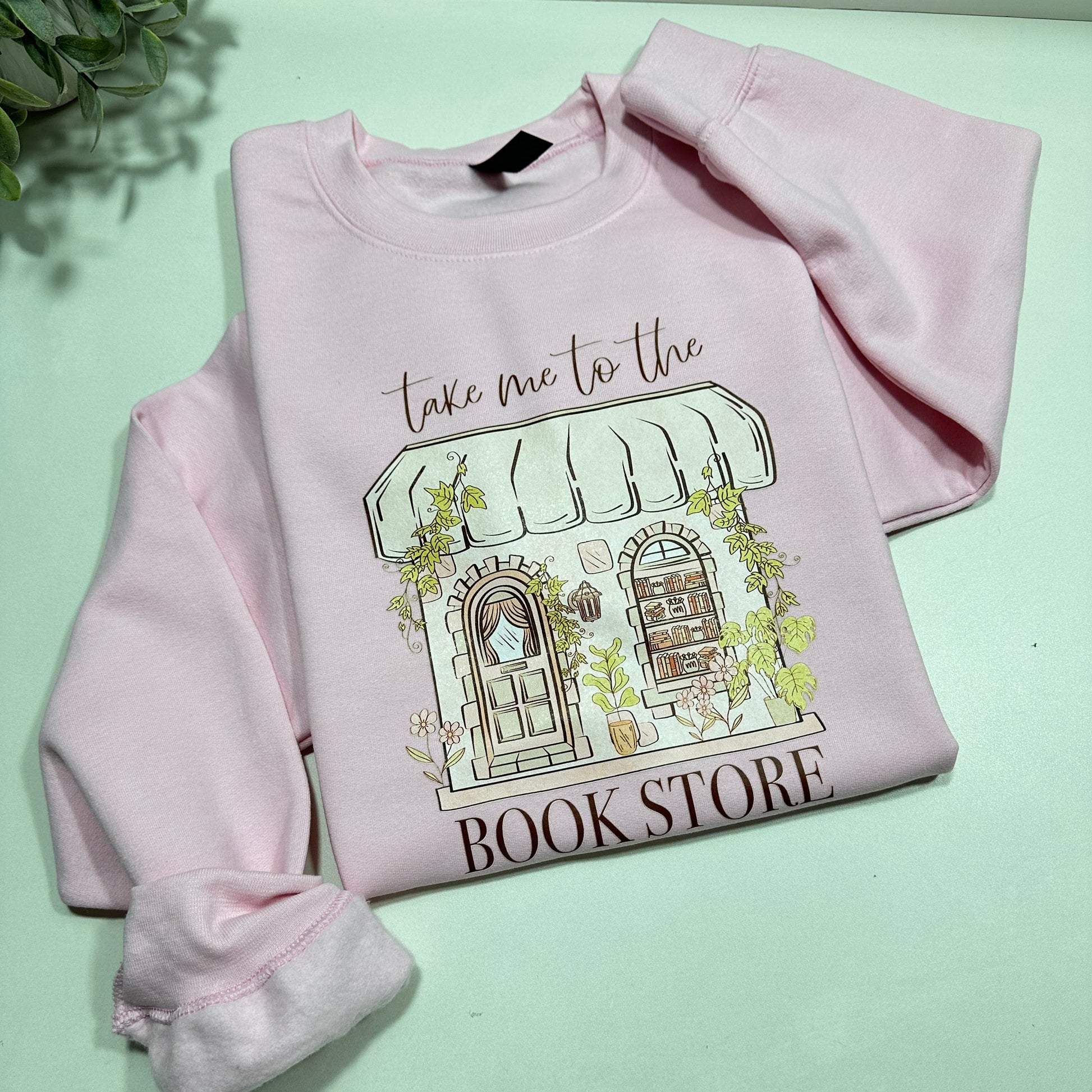 pink sweatshirt with an aesthetic library that said take to the bookstore