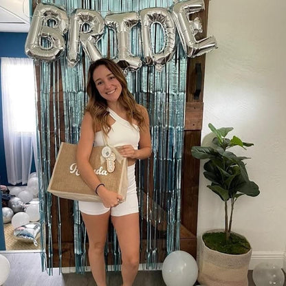 a bride with a personalized jute bag with her name